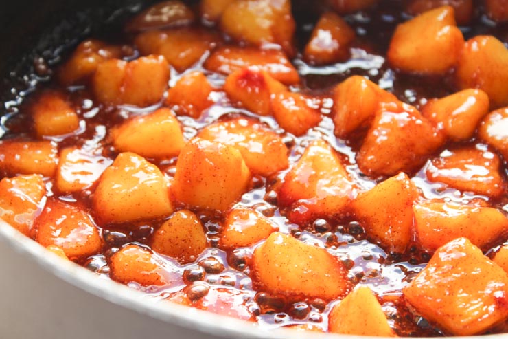 Simmering Peaches in Cinnamon Syrup