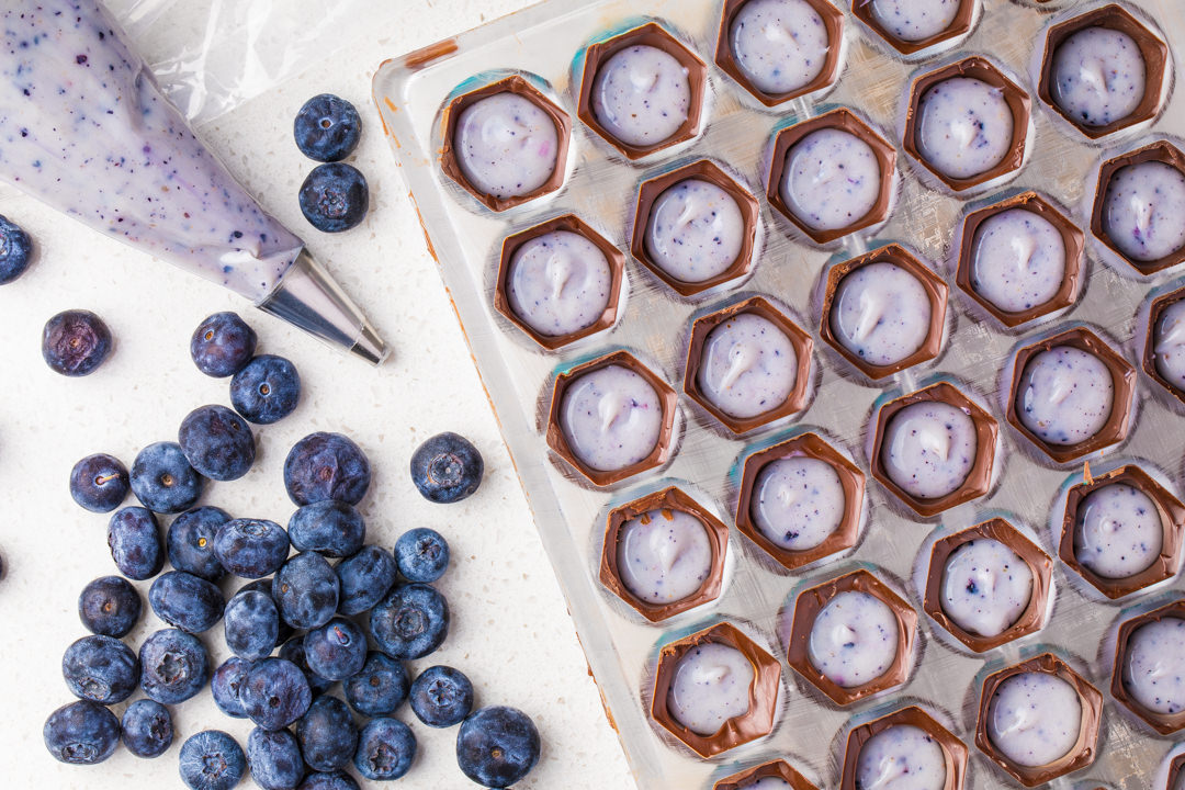 Filling the Chocolate Molds with Blueberry Ganache