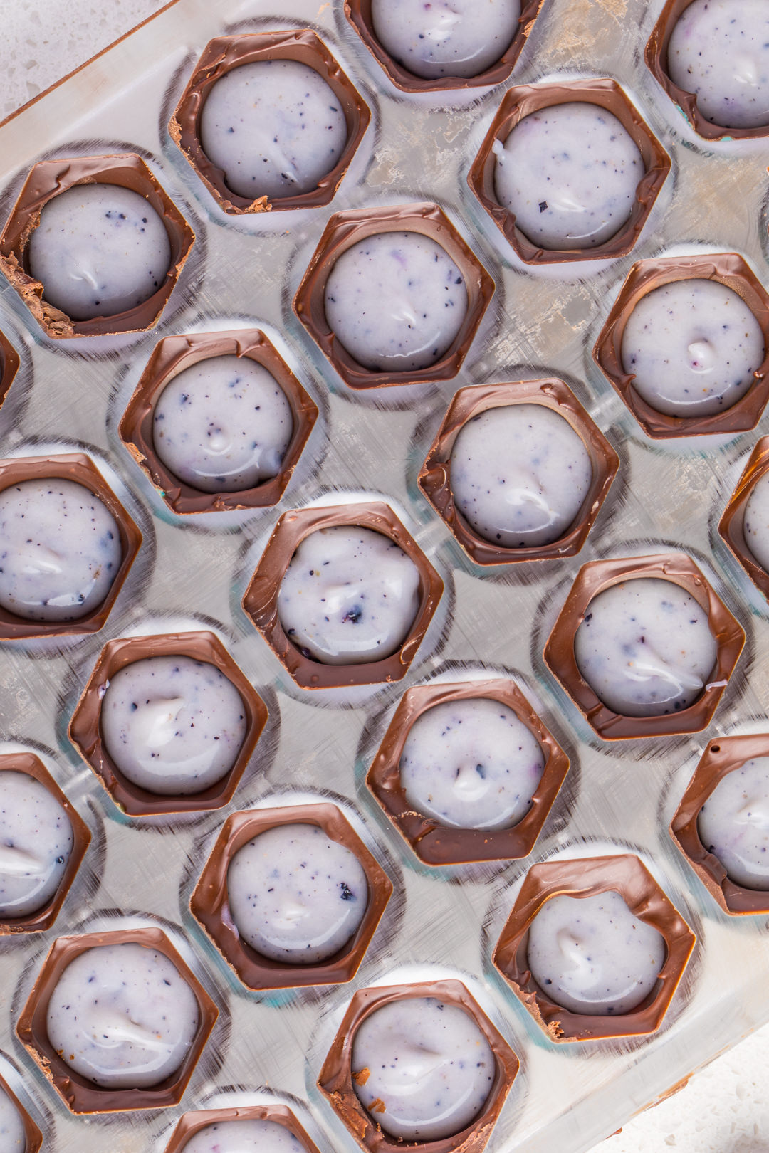 Filling the Chocolate Molds with Blueberry Ganache