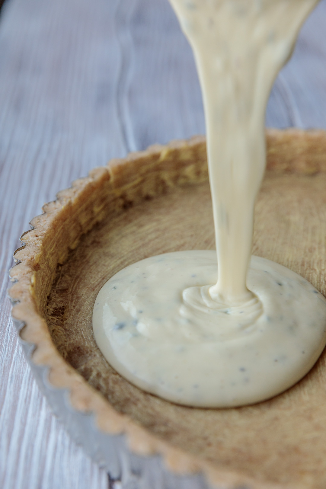 Filling the pastry shell with goat cheese herb custard